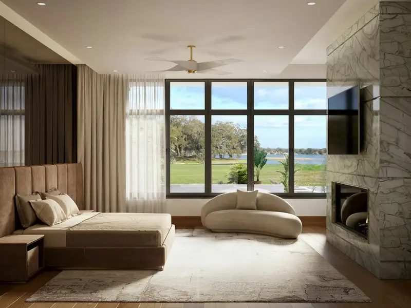 A bedroom with a stone fireplace wall and tall windows to the garden