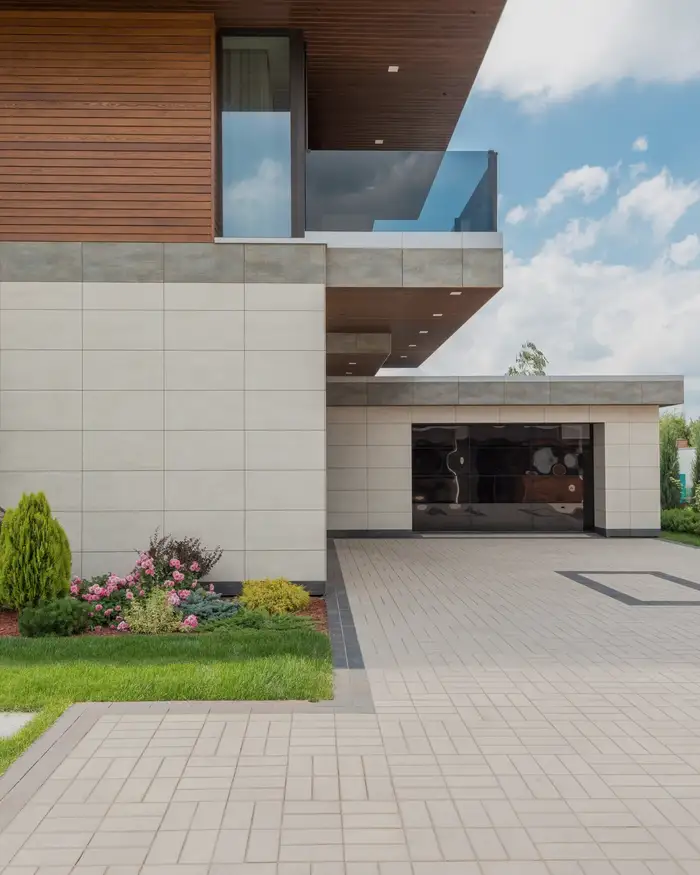 A modern house of stone and wood with a cantilevered upper floor